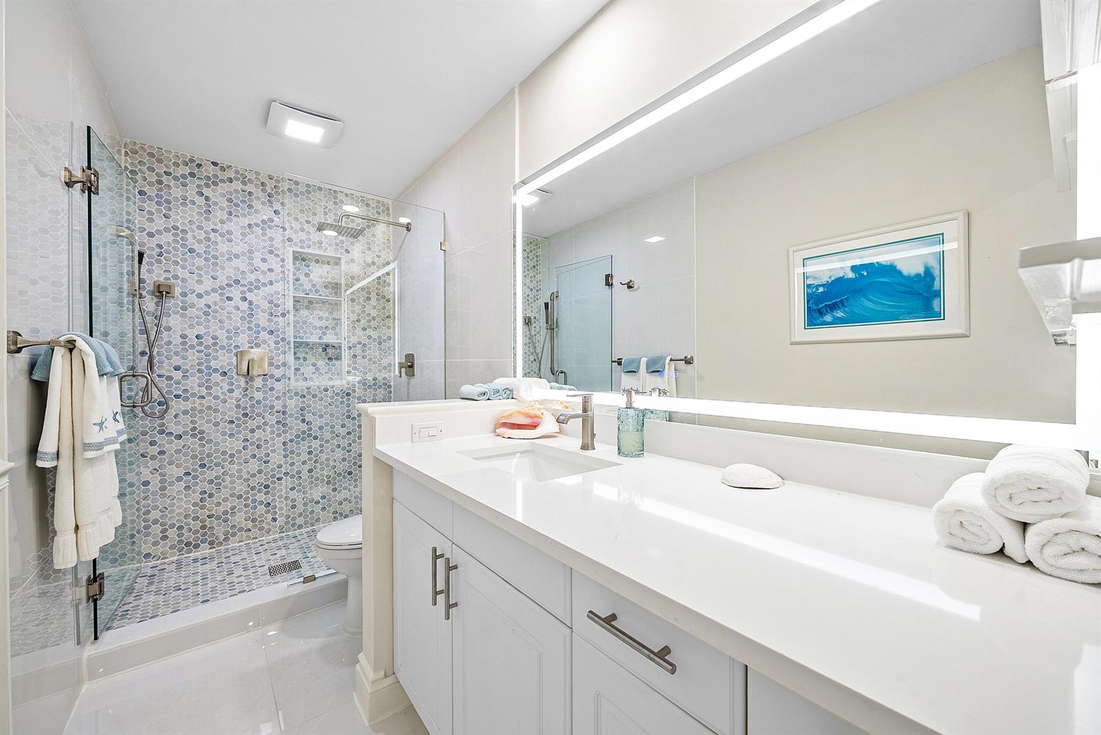 A bathroom features a glass-enclosed shower with blue mosaic tiles and a white vanity — 2016 SW 29th Court, Delray Beach FL 33445, DELRAY BEACH, FL