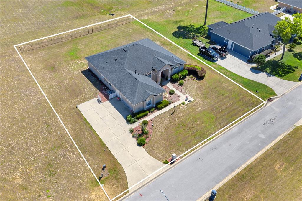 An aerial view shows a single-story house with a fenced yard and concrete driveway — 6426 SE 10TH STREET, OCALA, FL