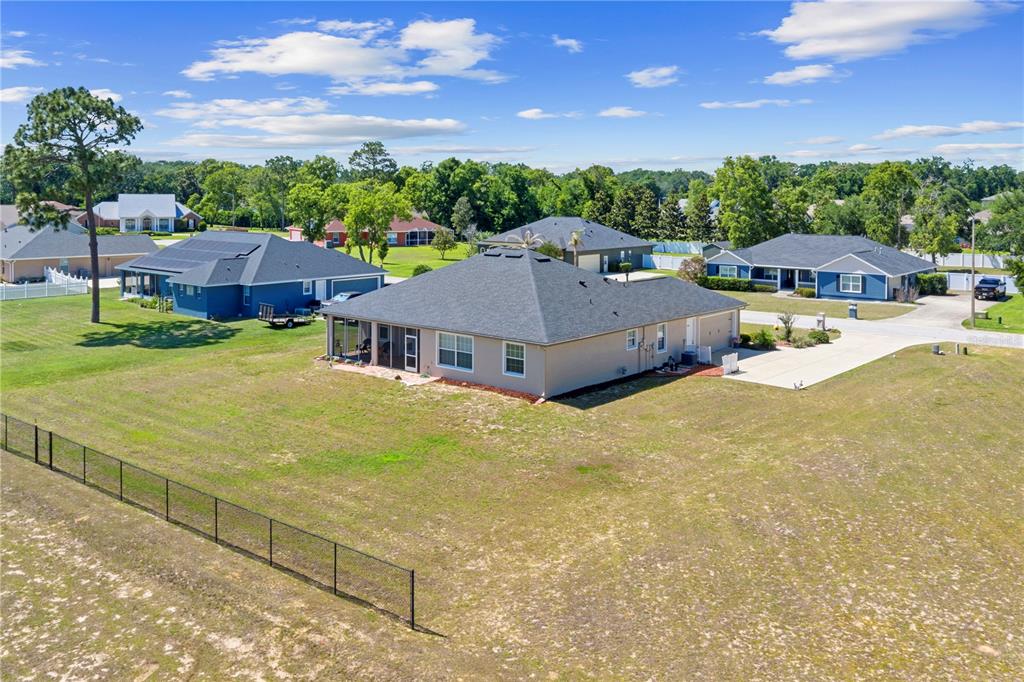 An aerial view shows a tan single-story house with a dark roof and fenced yard — 6426 SE 10TH STREET, OCALA, FL