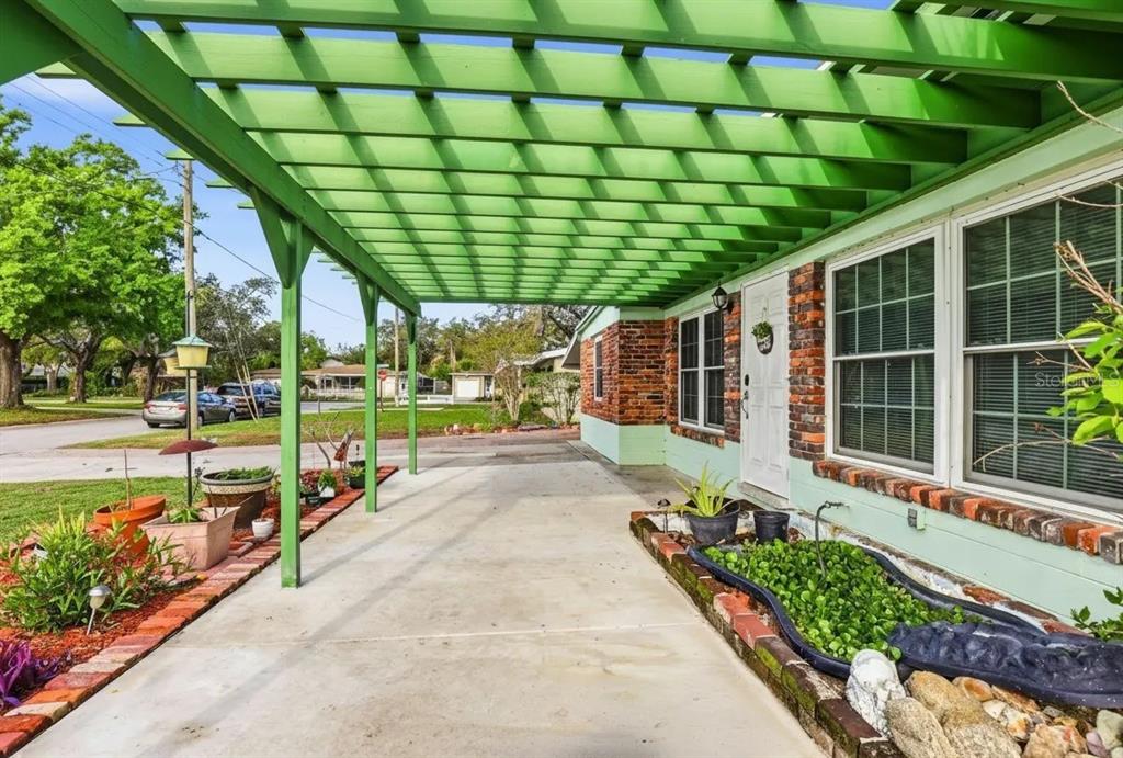 A kitchen area features a blue coffee bar, wood-look flooring, and exposed ceiling beams — 713 W 116TH AVENUE, TAMPA, FL