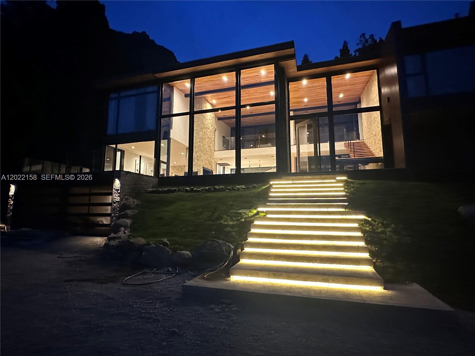 A modern two-story house with large glass windows and illuminated stairs at night — Lote A2-2 Lote A2-2, FL, FL