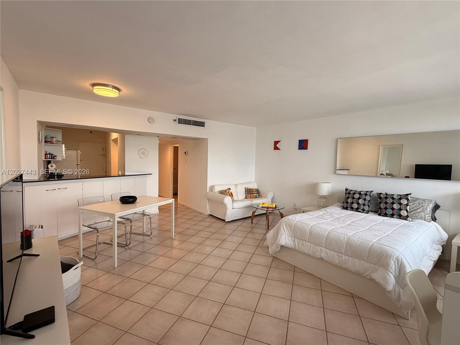 A studio apartment features a kitchen, dining area, living space, and bed on tiled floors — 100 Lincoln Rd # 1427, Miami Beach FL 33139, MIAMI BEACH, FL