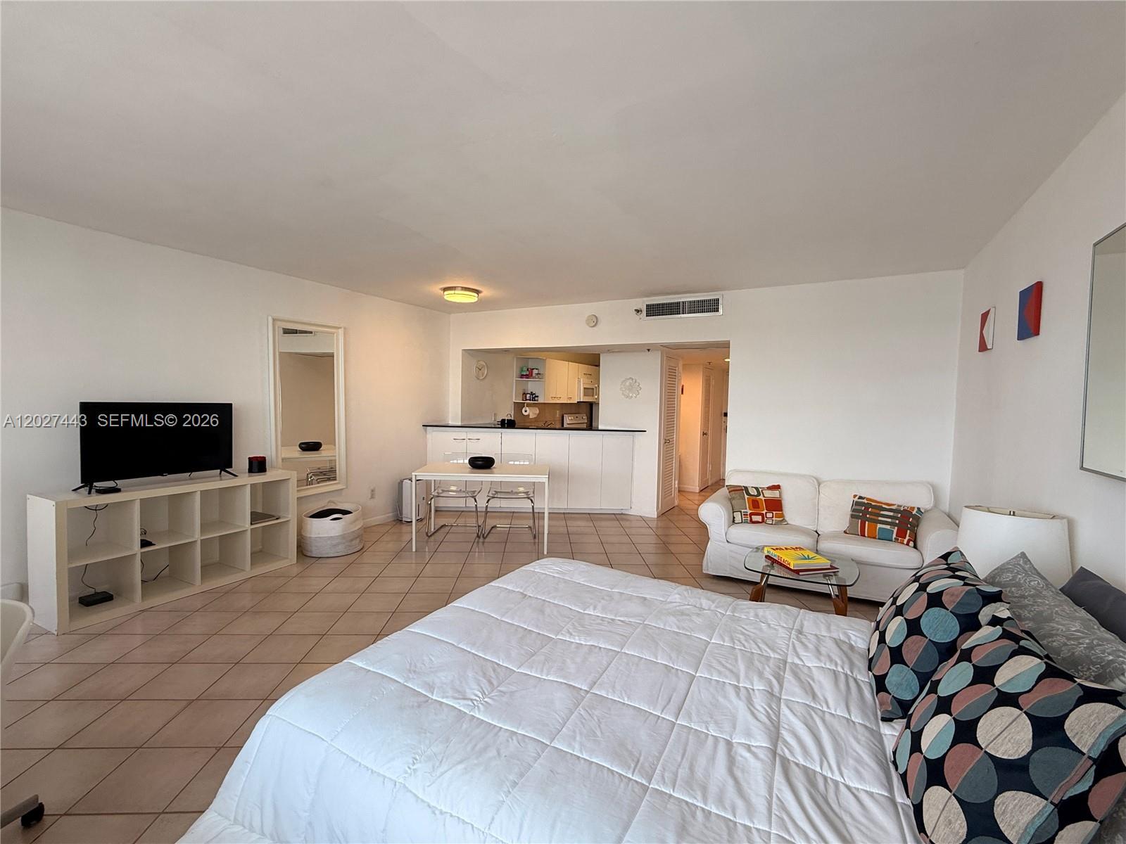 A studio apartment features a bed, a small dining area, and an open kitchen — 100 Lincoln Rd # 1427, Miami Beach FL 33139, MIAMI BEACH, FL