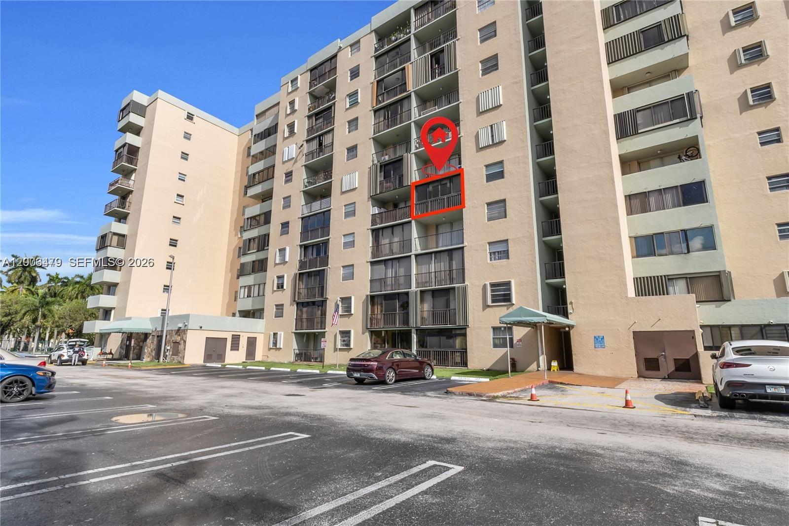 The exterior of a multi-story apartment building features a highlighted balcony on an upper floor — 5055 NW 7th St # 504, Miami FL 33126, MIAMI, FL