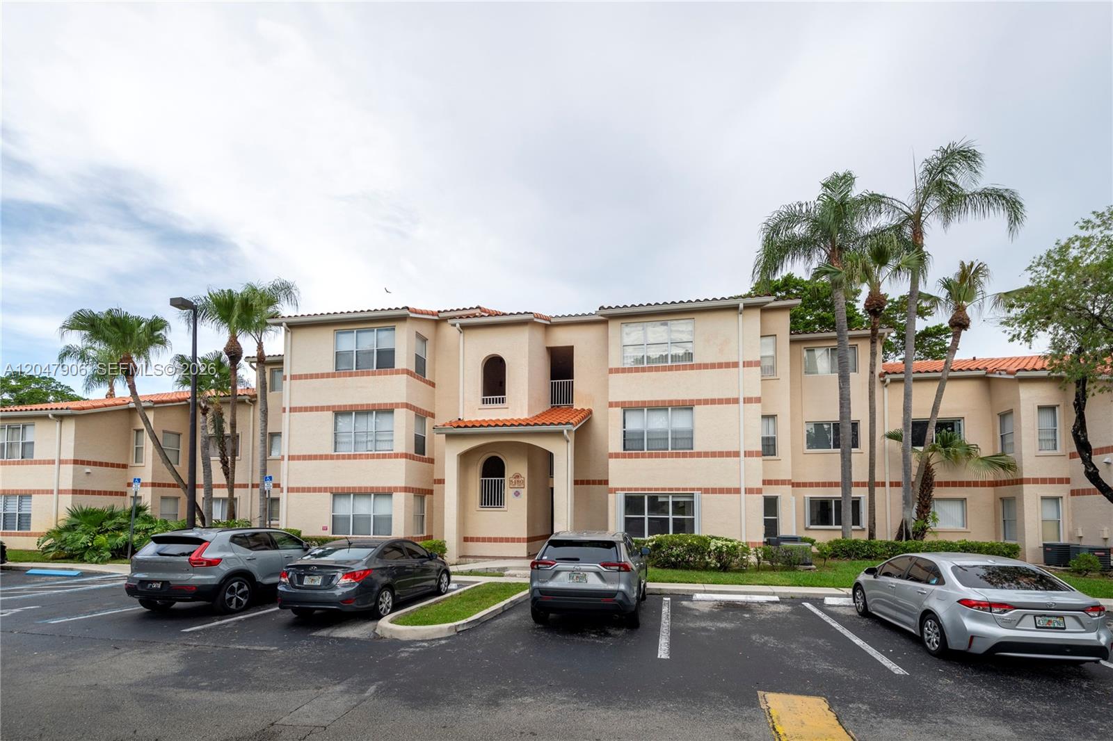 A three-story apartment building with a beige stucco exterior and a red tile roof — 3480 N Pinewalk Dr N # 116, Margate FL 33063, MARGATE, FL
