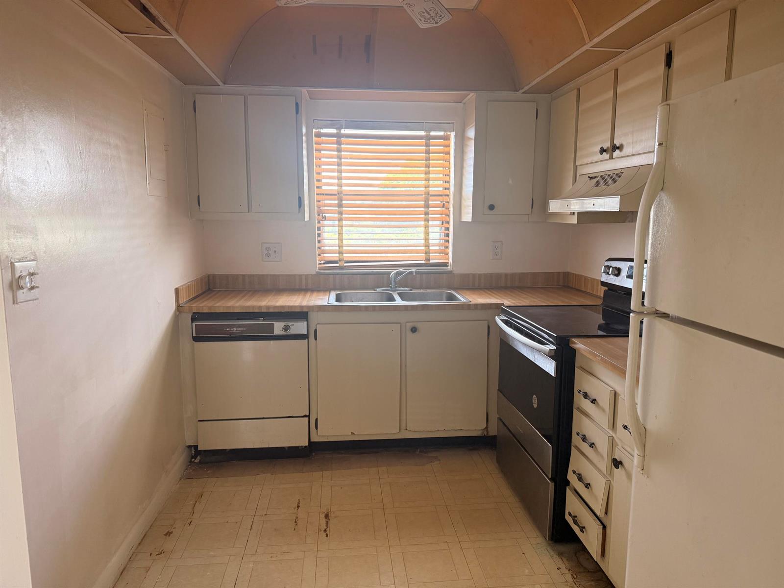 A kitchen with white cabinets, a window, a dishwasher, a stove, and a refrigerator — 2021 W Woolbright Road # G205, Boynton Beach FL 33426, BOYNTON BEACH, FL