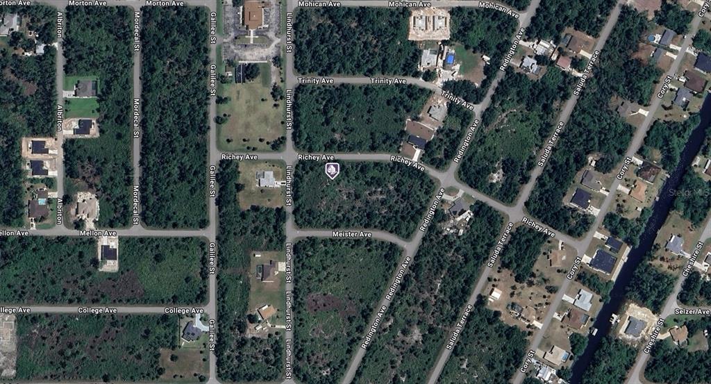 This is an aerial map view of a residential neighborhood with wooded lots and streets — 12507 RICHEY AVENUE, PORT CHARLOTTE, FL