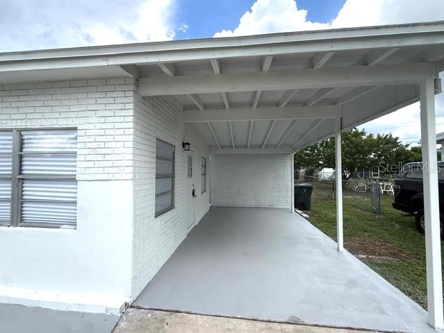 A sunroom features white paneled walls, a vaulted beamed ceiling, and light-colored tile flooring — 8766 PORTO BELLO AVENUE, NORTH PORT, FL