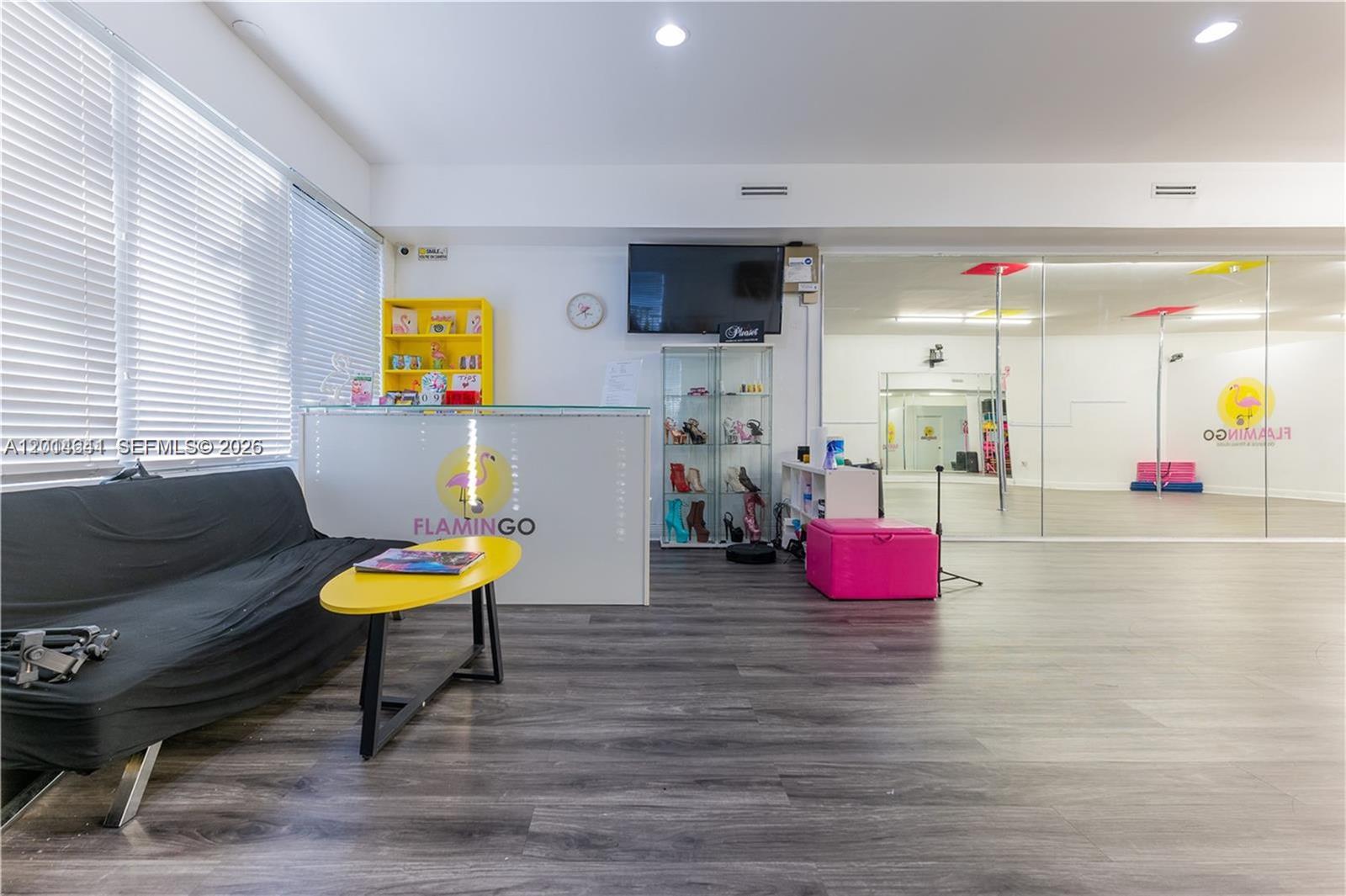 A studio space features a reception desk, a black sofa, and a mirrored dance area — 727 S 21st Ave, Hollywood FL 33020, HOLLYWOOD, FL