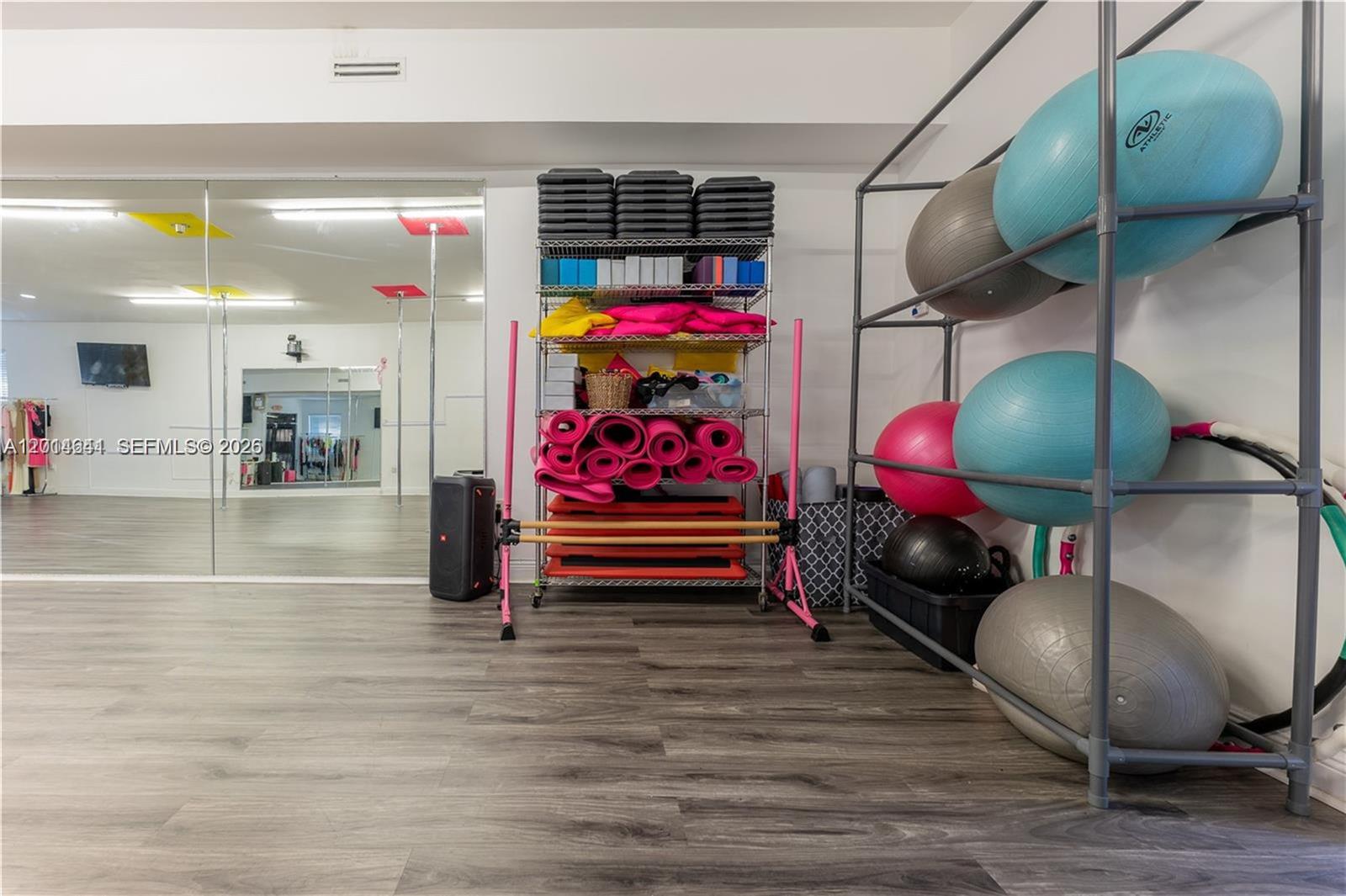 A fitness studio features a metal storage rack, exercise balls, and a mirrored wall — 727 S 21st Ave, Hollywood FL 33020, HOLLYWOOD, FL