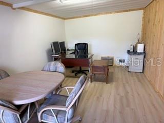 An office space features a wooden desk, a round table with chairs, and light-colored flooring — 2532 AMYRIS COURT UNIT 601, ZELLWOOD, FL