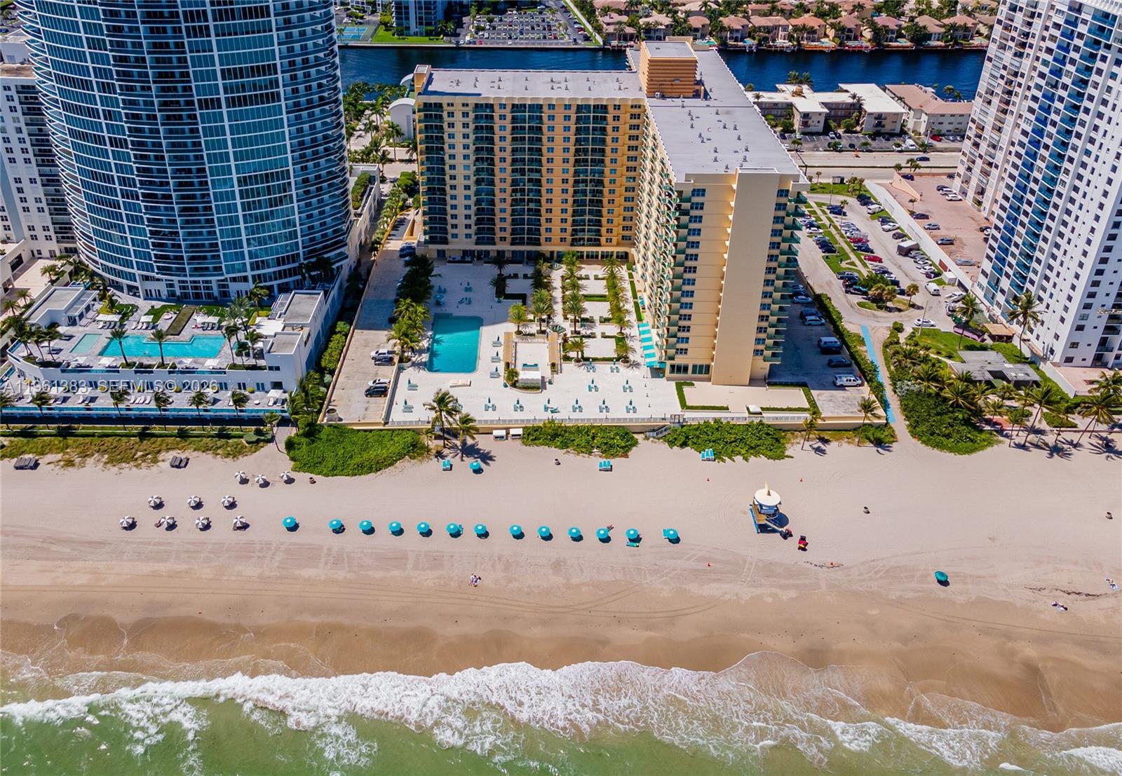 An aerial view shows a beachfront high-rise building with a pool deck and parking lot — 2501 S Ocean Dr # 1617, Hollywood FL 33019, HOLLYWOOD, FL