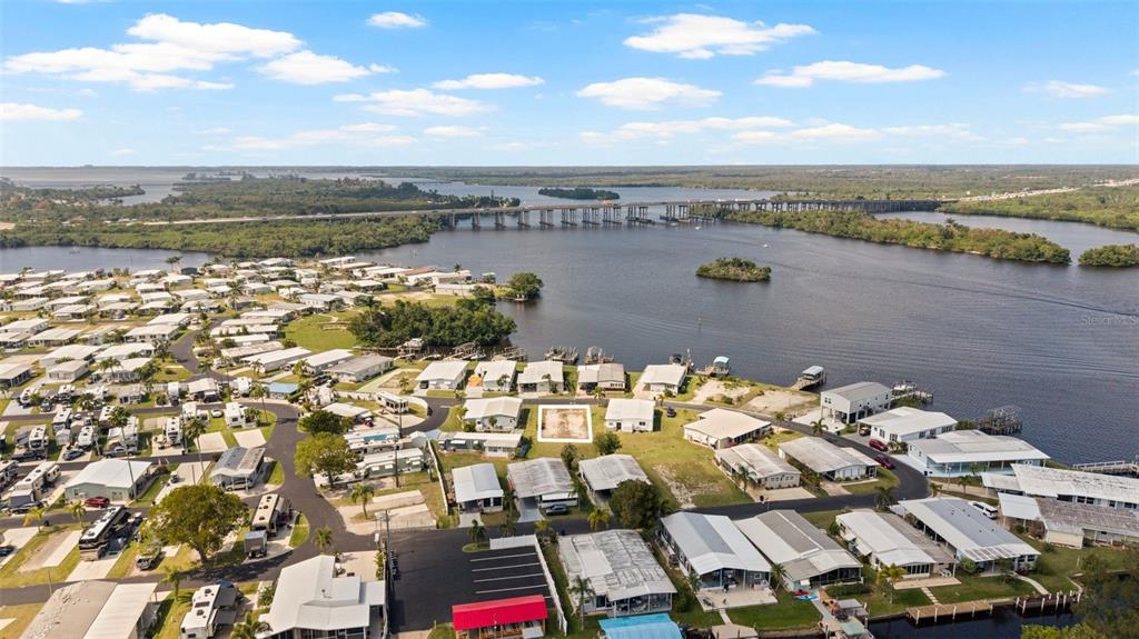 An aerial view shows a waterfront mobile home community with a vacant lot highlighted — 362 SHORELAND DRIVE, FORT MYERS, FL