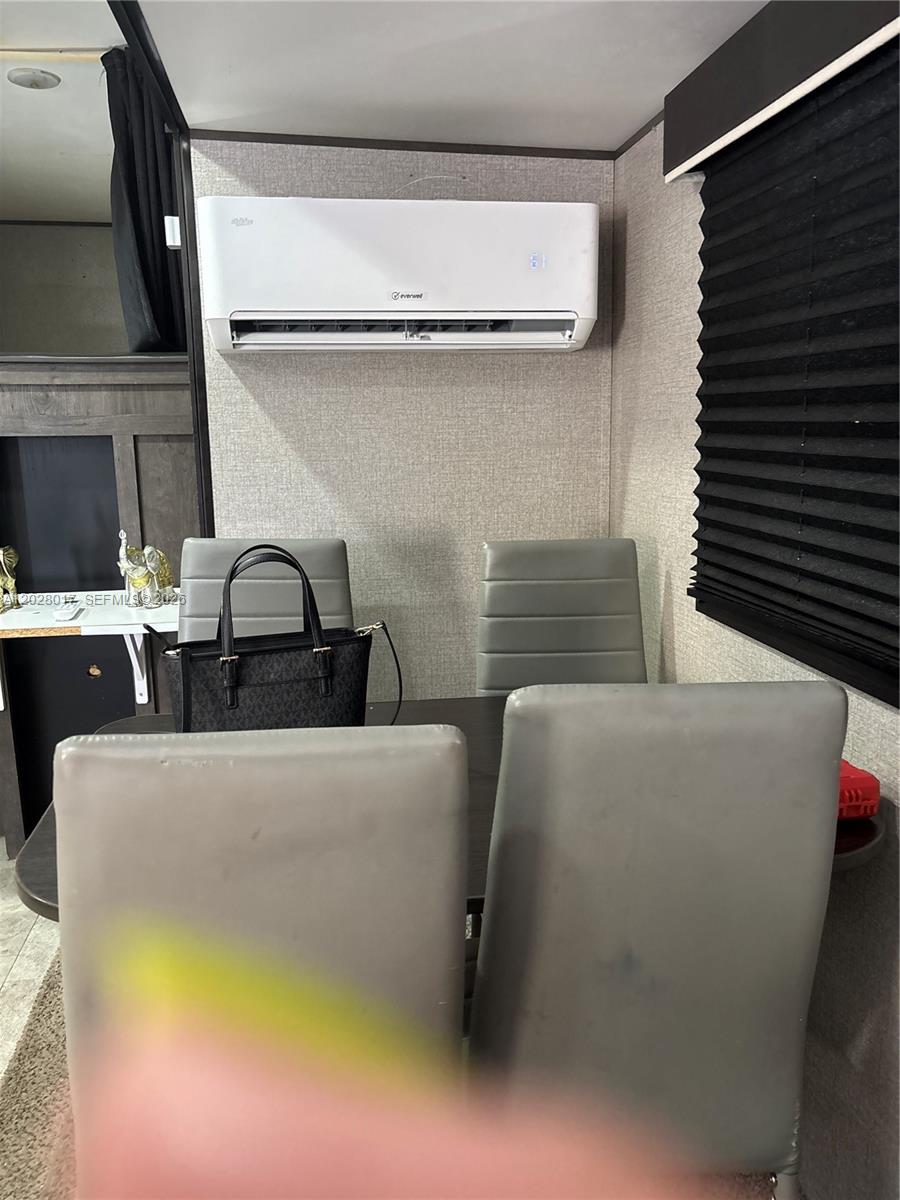 A dining area features a table, four grey chairs, and a wall-mounted air conditioner — 14165 NW 22nd Ct # A, Opa-Locka FL 33054, OPA-LOCKA, FL