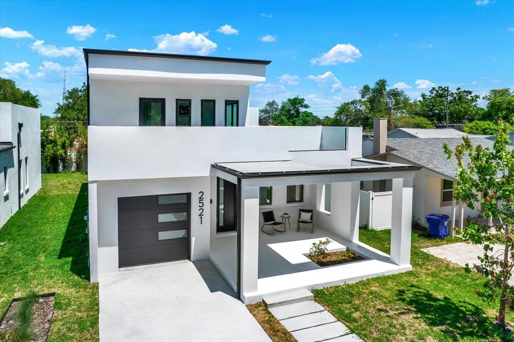 A modern two-story white house features a flat roof, a garage, and a covered porch — 2521 18TH AVENUE N, ST PETERSBURG, FL