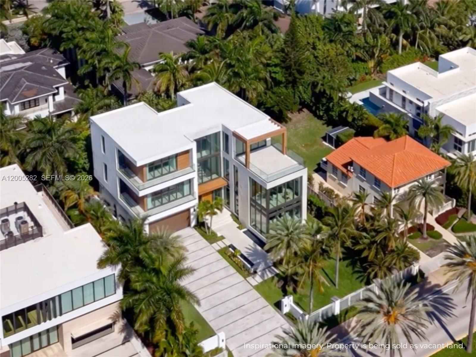 An aerial view of a modern multi-story house with a flat roof and glass walls — 254 Ocean Blvd, Golden Beach FL 33160, GOLDEN BEACH, FL