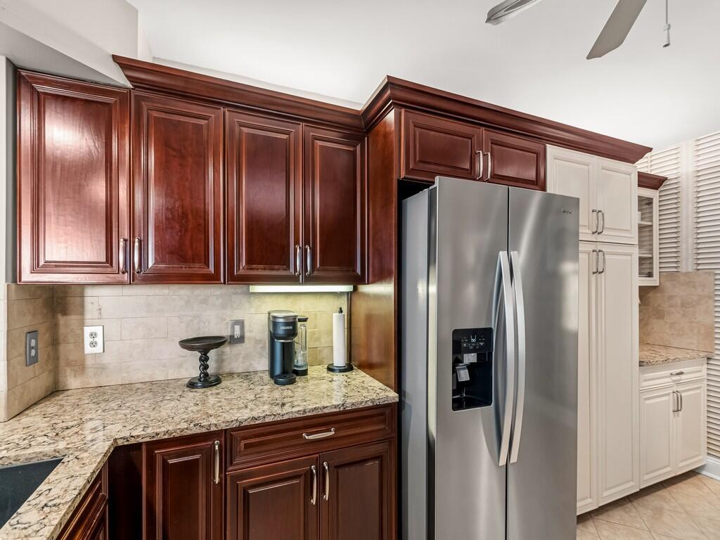 A view from an open doorway looking down a tiled hallway toward a balcony view — 9960 S Ocean Drive # 1905, Jensen Beach FL 34957, JENSEN BEACH, FL