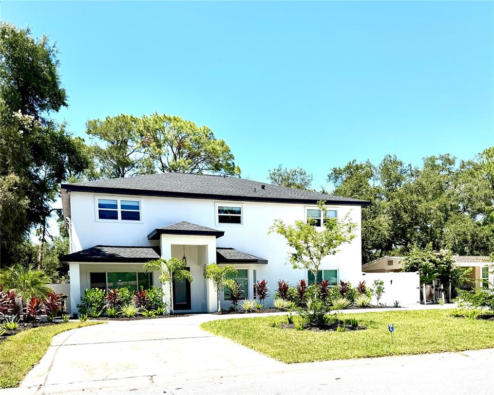 A two-story white house with a dark roof and a paved driveway — 2655 BAY STREET, SARASOTA, FL
