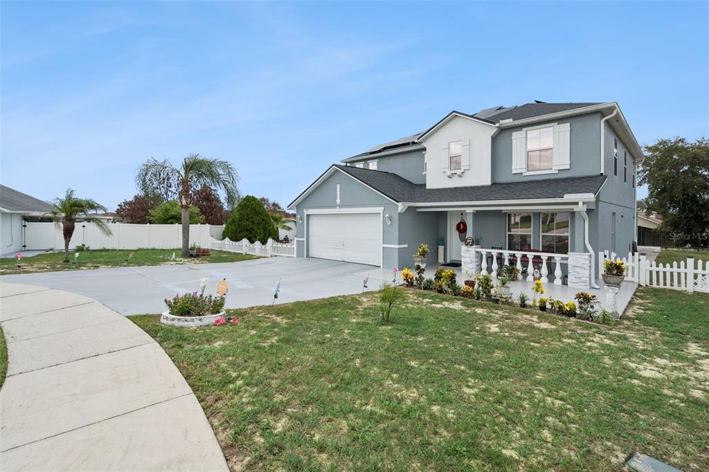 A two-story house with a gray exterior, a two-car garage, and a front porch — 7506 FORDHAM CREEK LANE, ORLANDO, FL