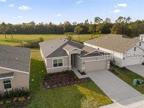 An aerial view shows a suburban house with a gray roof and a concrete driveway — 4385 PEBBLES THROW DRIVE UNIT B, KISSIMMEE, FL