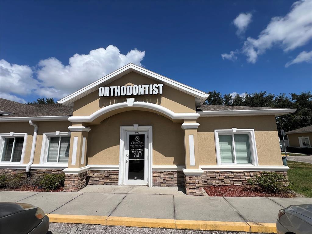 A single-story commercial building with a parking lot, wheelchair ramp, and a red fire hydrant — 13135 KINGS LAKE DRIVE UNIT 103, GIBSONTON, FL