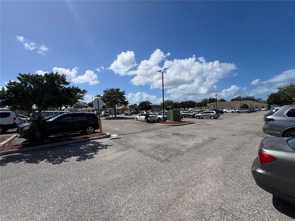 The exterior of a single-story commercial building features a front entrance and a wheelchair ramp — 13135 KINGS LAKE DRIVE UNIT 103, GIBSONTON, FL