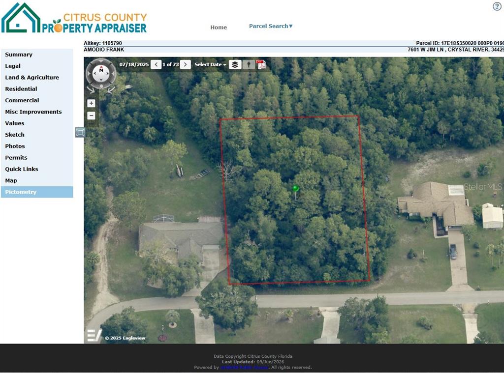 This aerial map view shows a wooded, rectangular residential lot outlined in red — 7601 W JIM LANE, CRYSTAL RIVER, FL