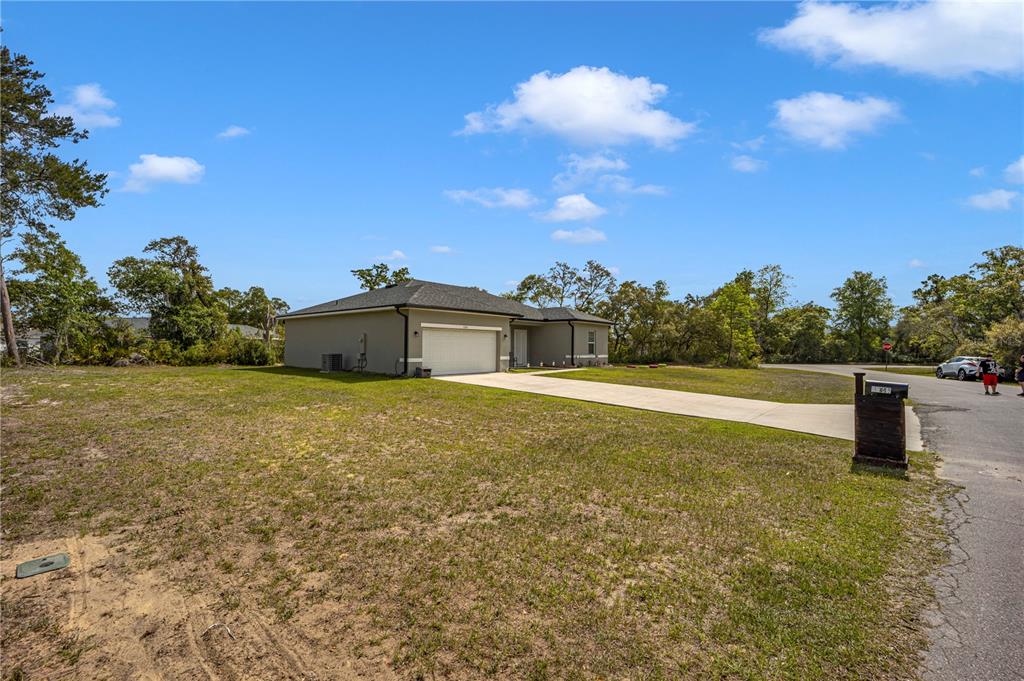 A single-story house with a two-car garage and a concrete driveway sits on a lot — 15841 SW 19TH TERRACE, OCALA, FL