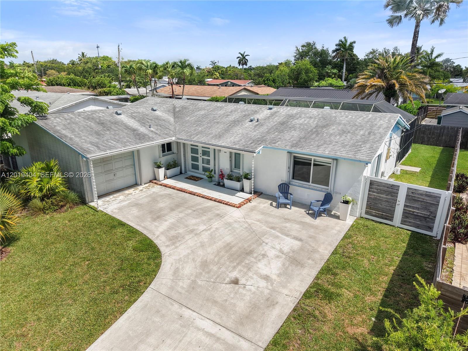 An aerial view shows a white single-story house with a concrete driveway and gray roof — 10455 SW 200th St, Cutler Bay FL 33157, CUTLER BAY, FL
