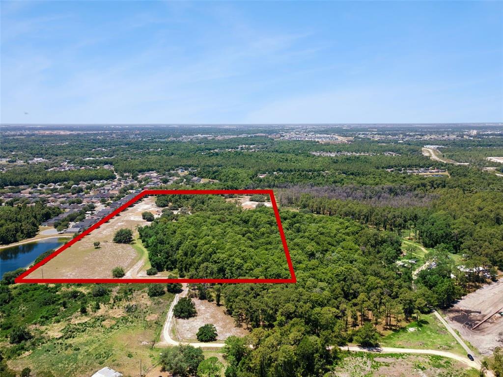An aerial view shows a large, rectangular plot of land outlined in red — BLUE JAY WAY, DAVENPORT, FL