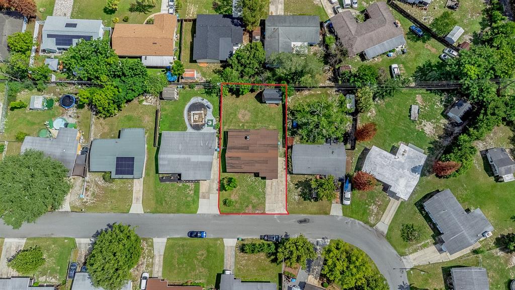 An aerial view shows a single-story house with a brown roof on a residential lot — 849 LOGAN DRIVE, LONGWOOD, FL