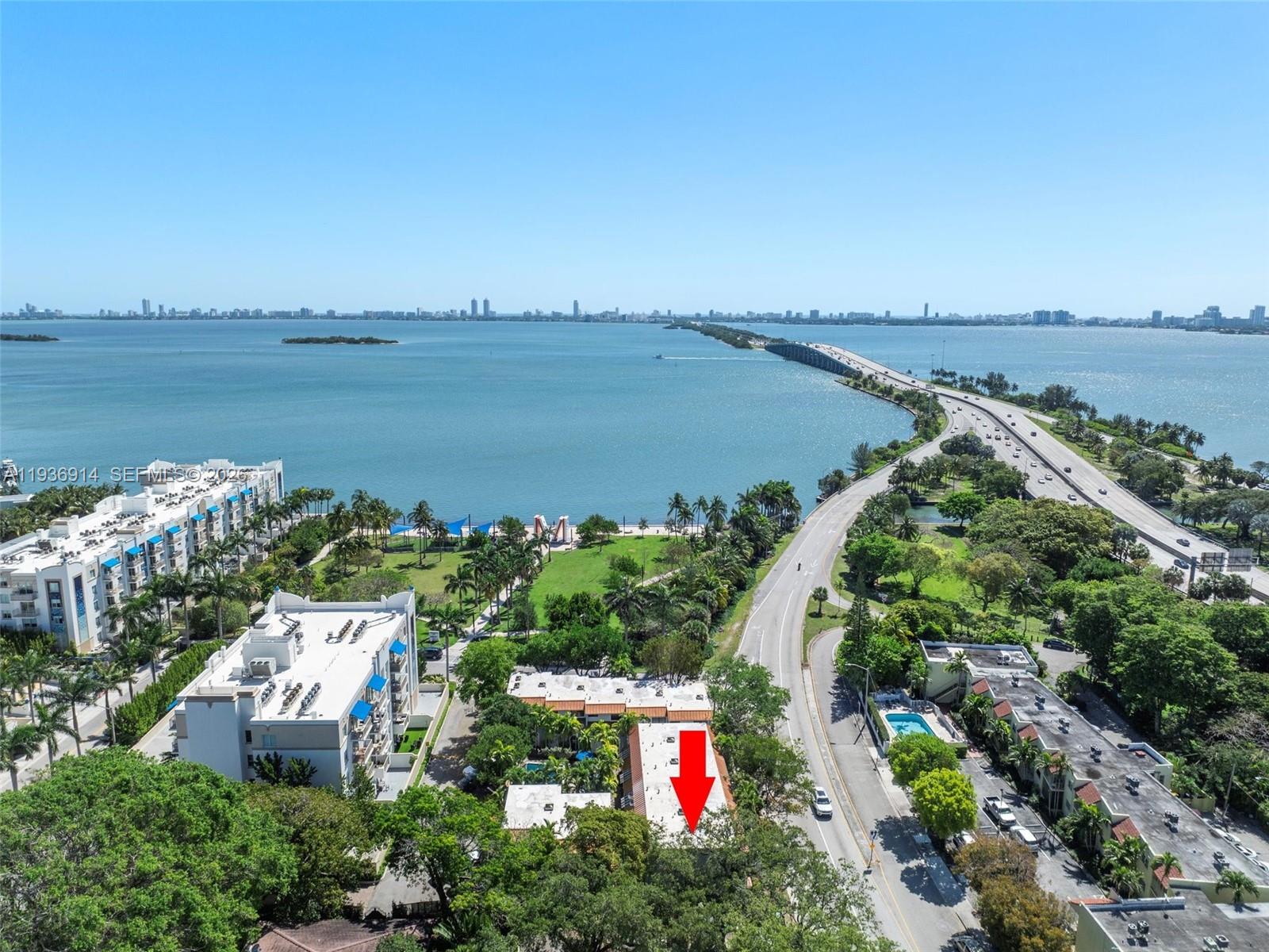 An aerial view shows a multi-story building with a red arrow pointing to its roof — 523 NE 38th St # 6, Miami FL 33137, MIAMI, FL
