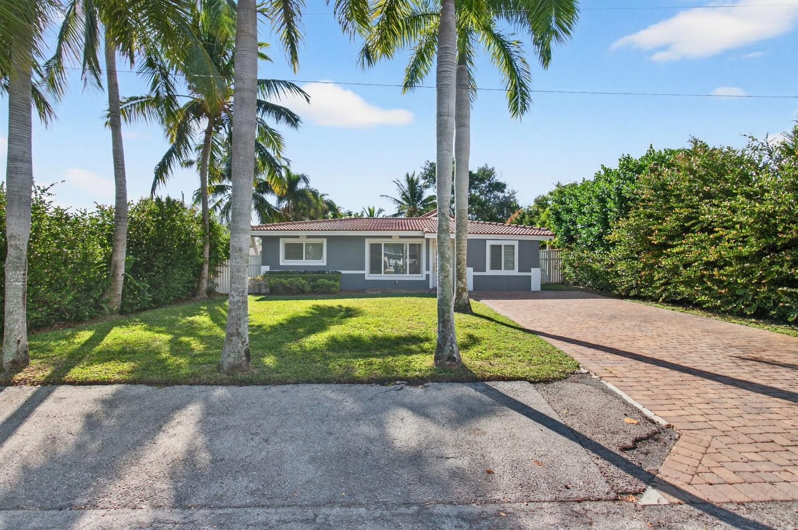 A gray single-story house with a tiled roof sits behind a lawn and palm trees — 360 SW 2nd Street, Boca Raton FL 33432, BOCA RATON, FL