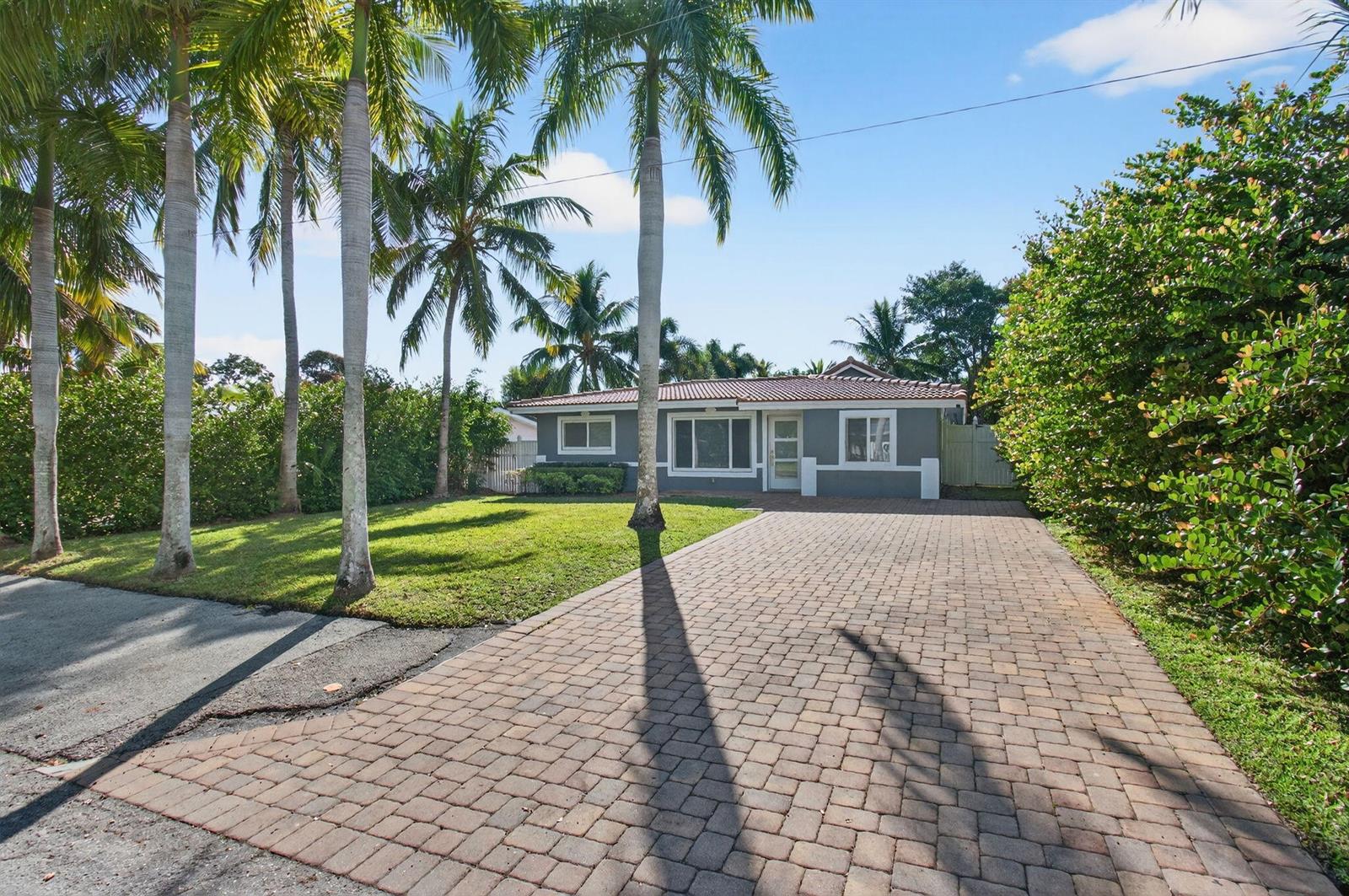 A gray single-story house with a tiled roof and a brick paver driveway — 360 SW 2nd Street, Boca Raton FL 33432, BOCA RATON, FL