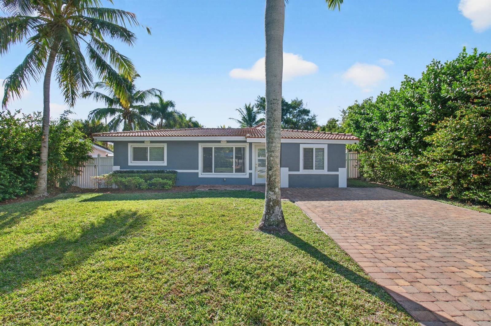 A single-story gray house with a tiled roof, brick driveway, and palm trees in front — 360 SW 2nd Street, Boca Raton FL 33432, BOCA RATON, FL