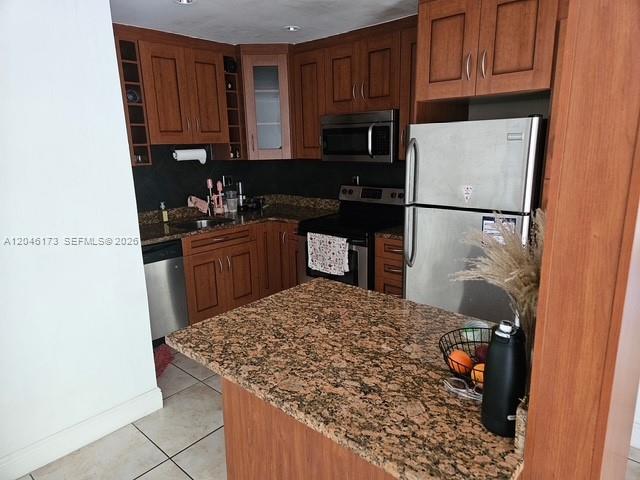 A kitchen features wood cabinets, granite countertops, and stainless steel appliances — 9483 SW 76th St # N8, Miami FL 33173, MIAMI, FL
