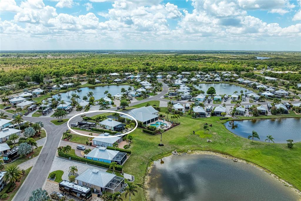 An aerial view shows a residential property with a motorhome parked beside a house — 8318 SW SAND CRANE CIRCLE LOT 86, ARCADIA, FL