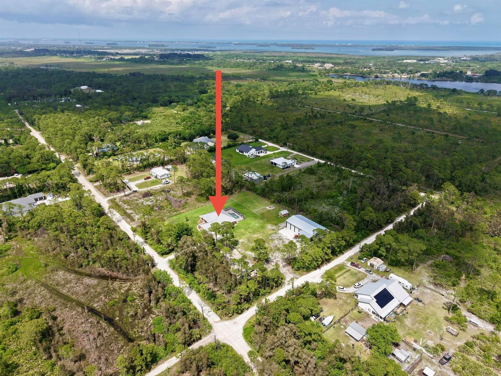 An aerial view shows a residential property with a pool and outbuilding in a rural area — 5224 Southwind Trail, Fort Pierce FL 34951, FORT PIERCE, FL