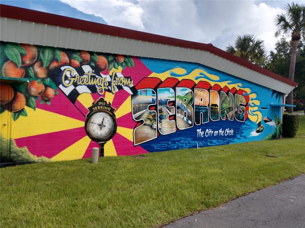 A large, colorful mural on the exterior wall of a building depicts the city of Sebring — 2217 ALGONQUIN DRIVE, SEBRING, FL