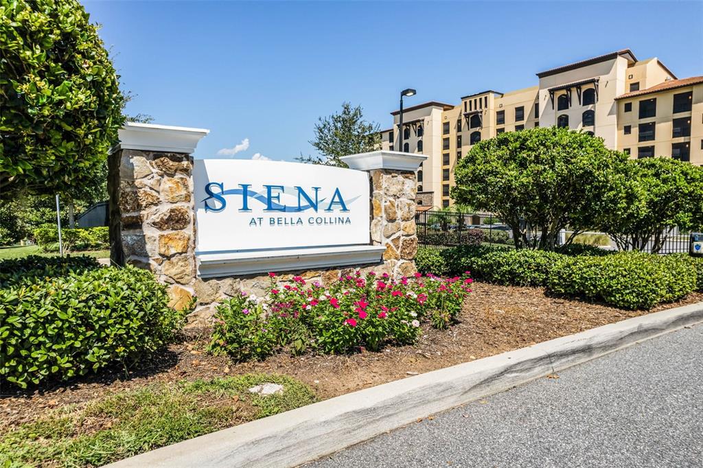 A stone monument sign for Siena at Bella Collina stands before a large apartment building — 16300 COUNTY ROAD 455 UNIT 503, MONTVERDE, FL