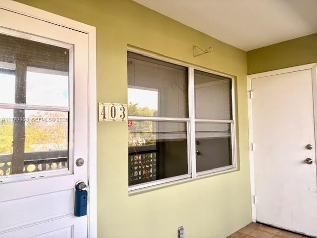 A light green exterior wall features a door, a window, and the number 403 — 1425 Arthur St # 403A, Hollywood FL 33020, HOLLYWOOD, FL