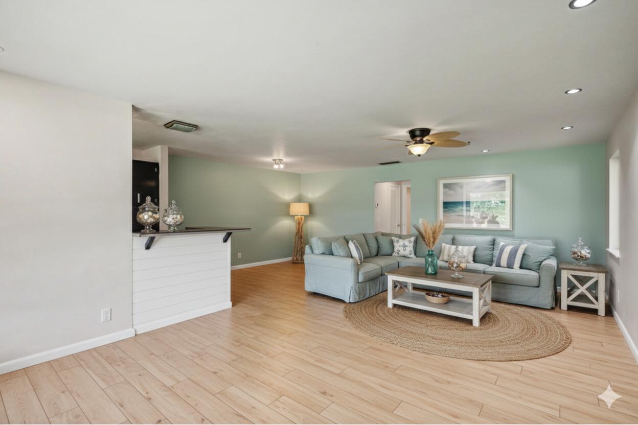 A living room with light wood floors, a sectional sofa, and a white bar counter — 275 South Boulevard # C, Boynton Beach FL 33435, BOYNTON BEACH, FL