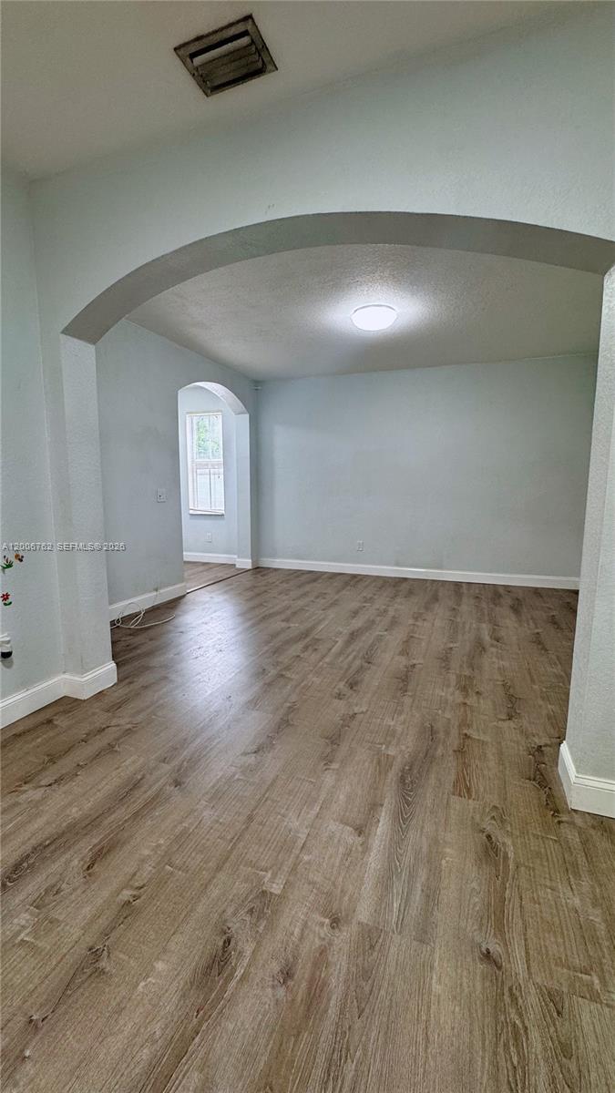 An interior view shows a living area with light blue walls and wood-look flooring — 15810 SW 40th St # 57, Miramar FL 33027, MIRAMAR, FL
