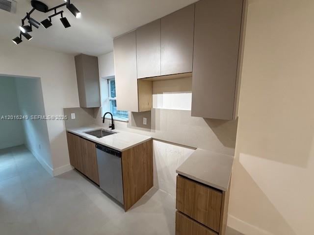 A kitchen features two-toned wood and grey cabinets, a stainless steel dishwasher, and track lighting — 328 NE 57th St, Miami FL 33137, MIAMI, FL