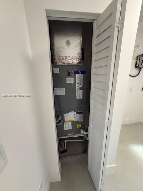 An HVAC air handler unit is installed inside a small utility closet with louvered doors — 328 NE 57th St, Miami FL 33137, MIAMI, FL