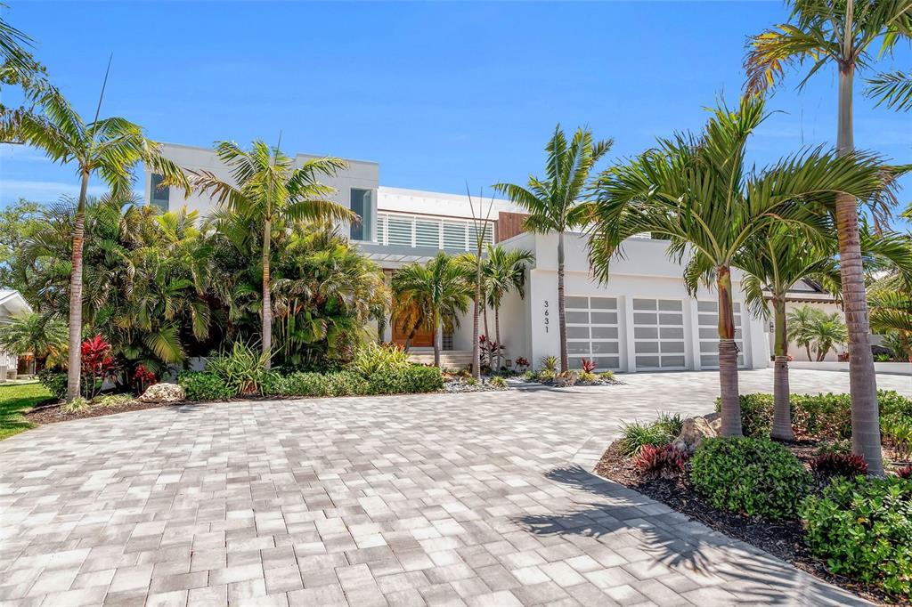 A modern white two-story house features a paved driveway and several palm trees — 3631 SAN REMO TERRACE, SARASOTA, FL