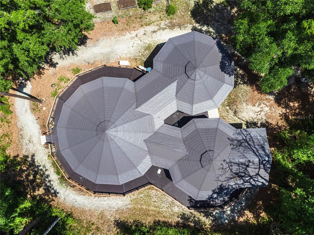 An aerial view shows a house with three connected circular roofs surrounded by trees — 13797 NE 199TH STREET, WALDO, FL