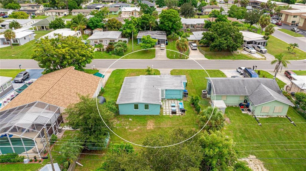 An aerial view shows a light blue house with a flat roof and backyard patio — 1023 ROBERTA STREET, VENICE, FL