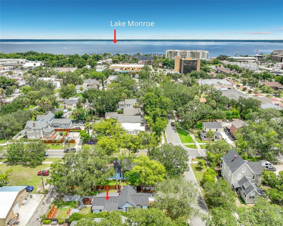 An aerial view shows a residential neighborhood with a house in the foreground near Lake Monroe — 306 S ELM AVENUE, SANFORD, FL