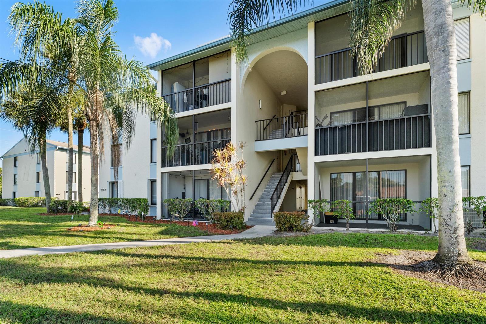 A three-story apartment building with screened balconies and an outdoor staircase — 1108 Green Pine Boulevard # A3, West Palm Beach FL 33409, WEST PALM BEACH, FL